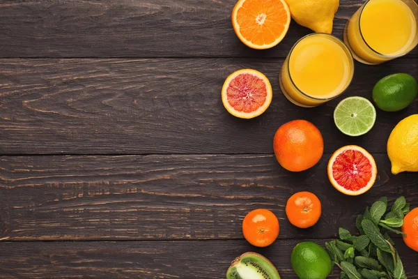 Variety of ripe citruses on wooden background