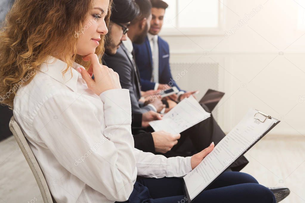 Group of business people sitting on chairs