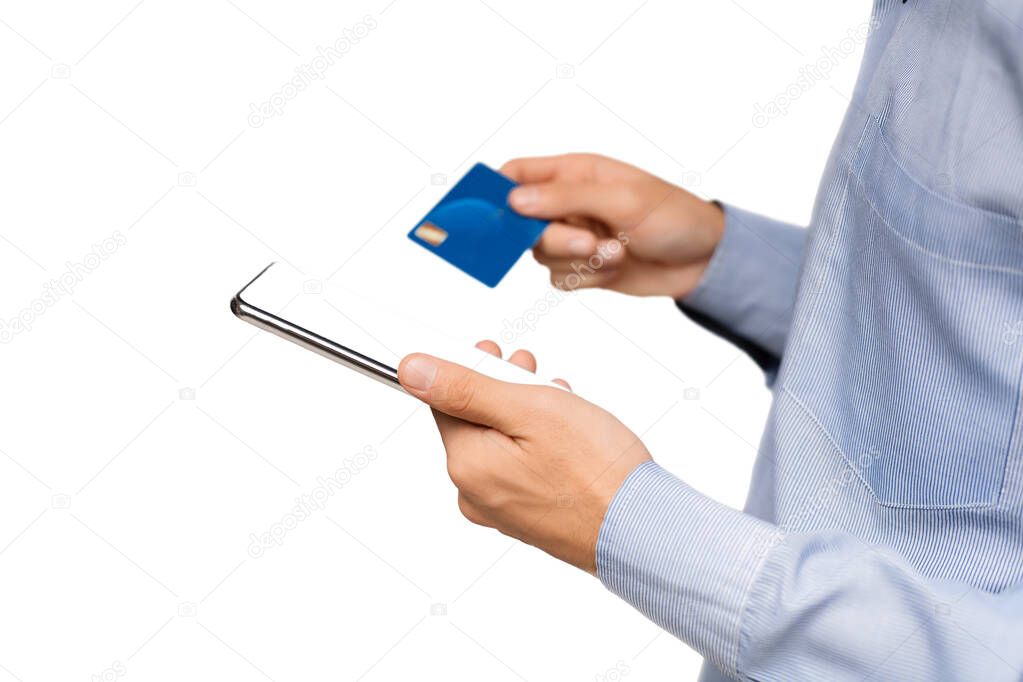 Unrecognizable man holding smartphone with blank screen and credit card.