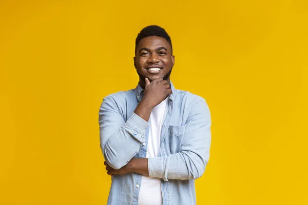 Portrait of handsome black guy touching his beard — Stock Photo, Image