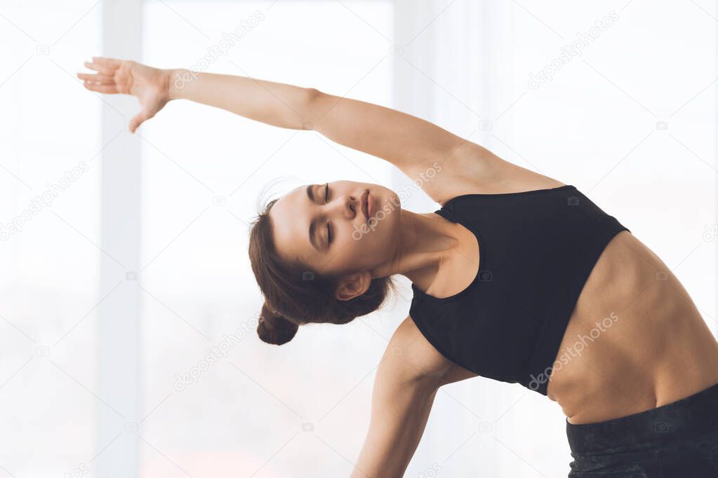 Fitness concept. Relaxed girl streching arms and exercising