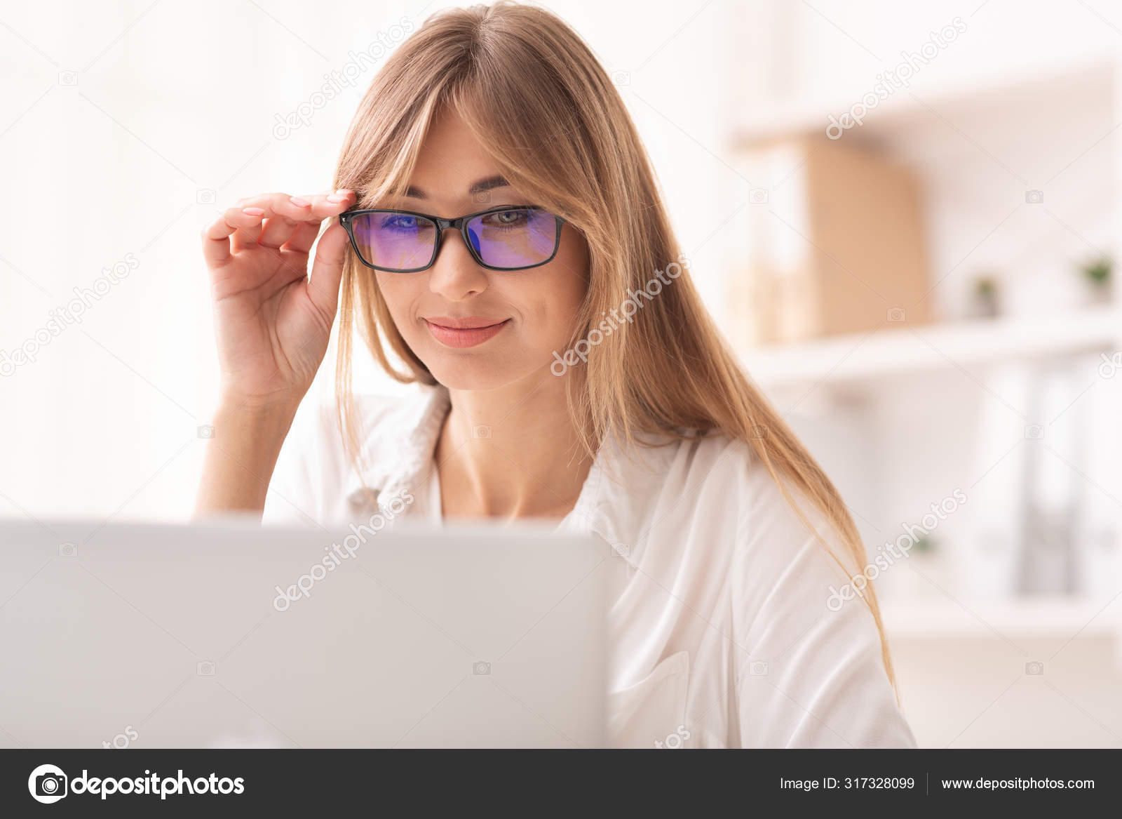 Smiling Lady Looking Through Eyeglasses At Laptop Working In