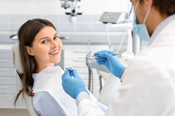 Glad kvinde gør check op i tandklinik - Stock-foto