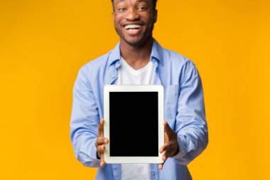 Siyah Adam Sarı Arkaplanda Boş Tablet Ekranı Gösteriyor.