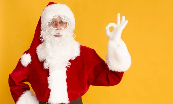 Weihnachtsmann mit guten Nachrichten und Ok-Zeichen auf orange — Stockfoto