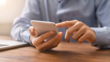 Akıllı telefon kullanarak para dengesini kontrol eden tanınmayan bir adam.
