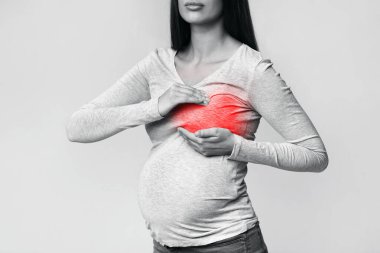 Unrecognizable Pregnant Woman Having Breast Pain Standing In Studio, Cropped clipart