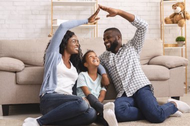 African couple making symbolic roof of hands above little girl clipart