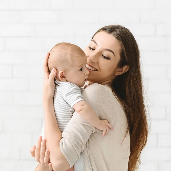 Portrait of young mother cuddling her adorable little child — Stock Photo, Image