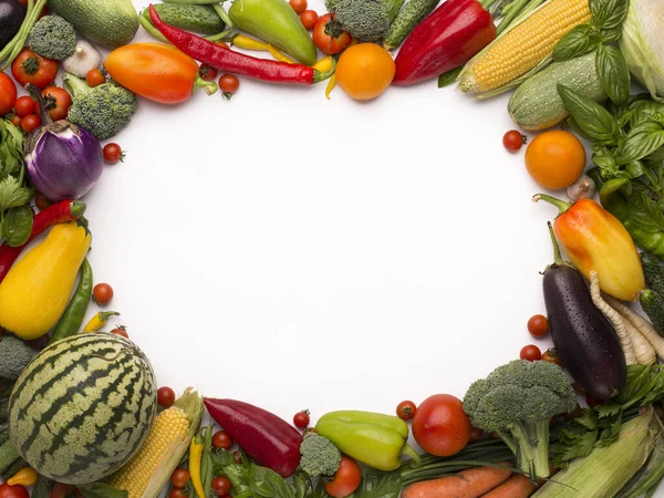 Oval frame of fresh fruits and vegetables on white