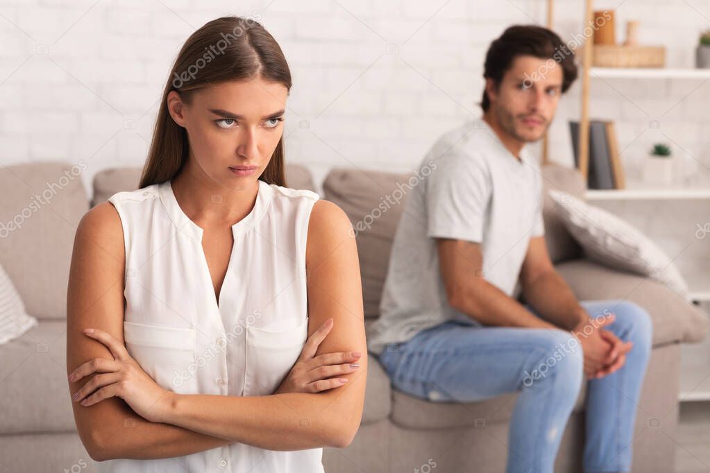 Angry Woman Standing Crossing Hands Dissatisfied With Boyfriends Behavior Indoor
