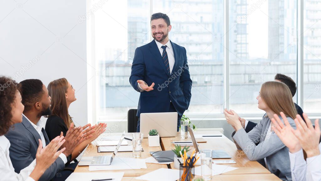 Business team congratulating successful manager with applause