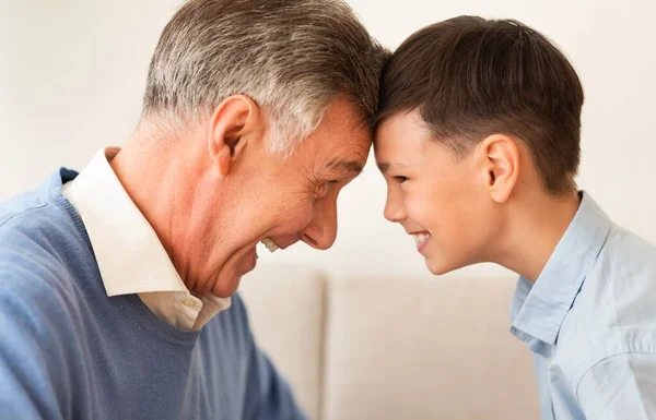 Nonno e nipote toccare fronte seduta su divano coperta — Foto Stock