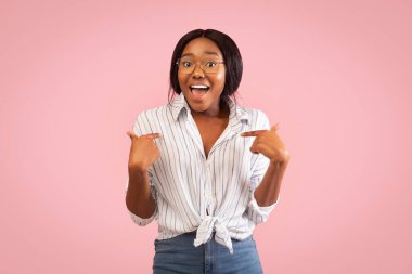 Black Girl Pointing Fingers At Herself Smiling Standing, Studio Shot clipart