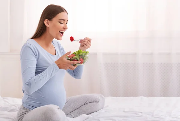 Pregnant Girl Eating Vegetable Salad Sitting On Bed In Bedroom — Stock Photo, Image