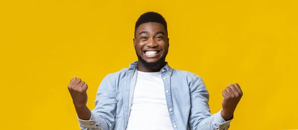 Χαρούμενος Αφροαμερικάνος που χαίρεται την επιτυχία με σφιγμένες γροθιές. — Φωτογραφία Αρχείου