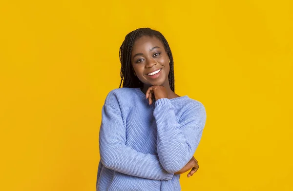 Interested afro lady smiling over yellow background — Stock Photo, Image