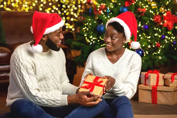 Щаслива жінка отримує різдвяний подарунок від свого люблячого чоловіка — стокове фото