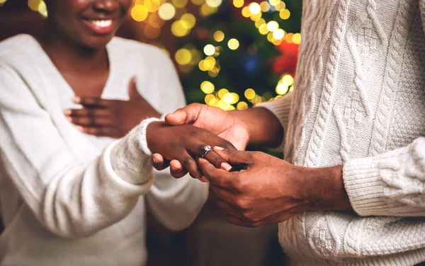 Black guy putting diamond ring on girlfriends finger after proposal — ストック写真