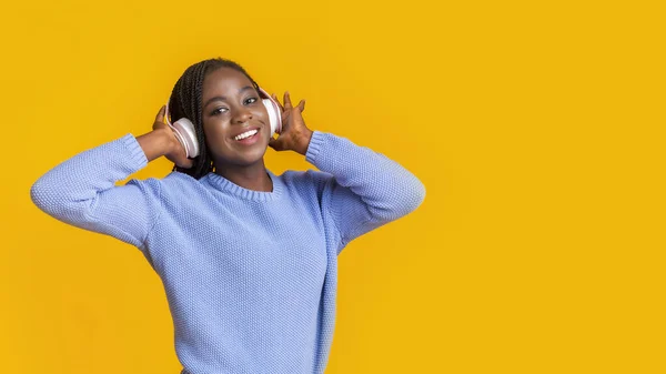 Souriant afro dame avec casque regardant l'espace libre — Photo