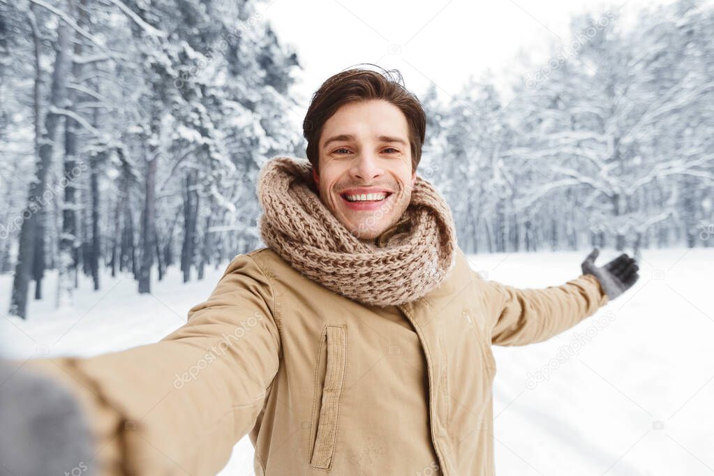 Happy Man Taking Selfie Standing In Winter Forest