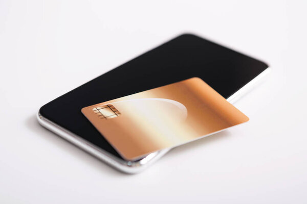 Credit card flat lying on modern smartphone with black screen