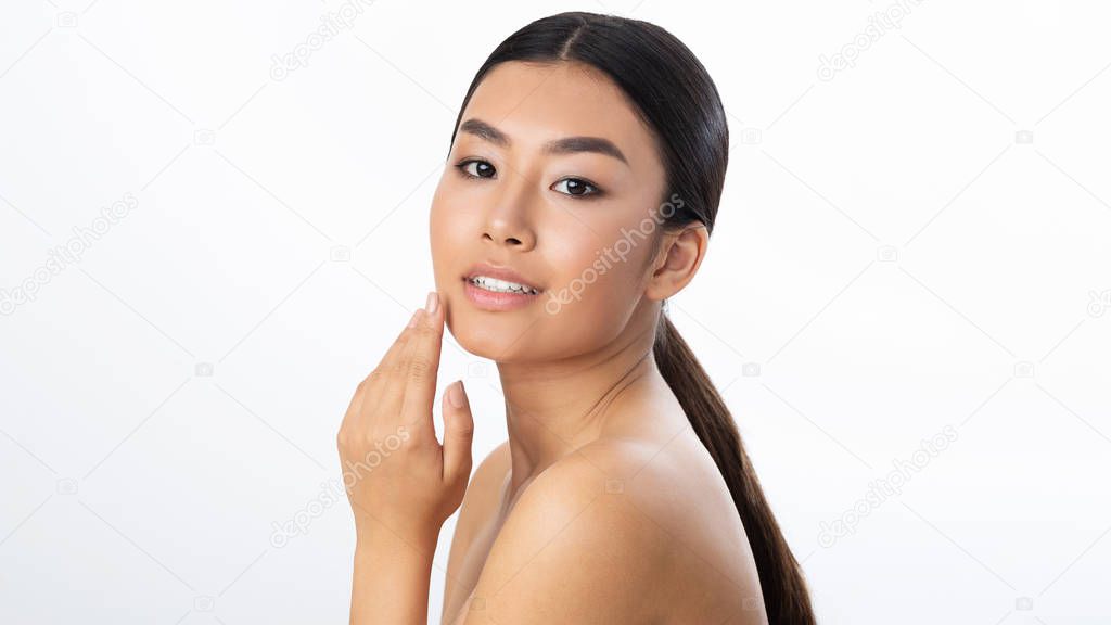 Face lifting concept. Young woman touching soft smooth skin