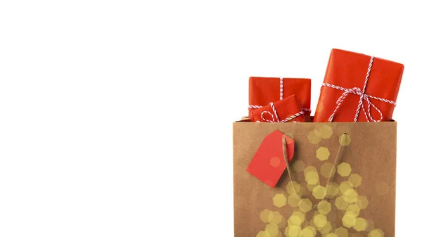 Close up of magic shopping bag full of Christmas gifts — Stock Photo, Image