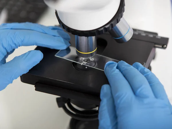 Close up of woman making analysis with microscope — Stock Photo, Image