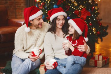 Dost canlısı aile Noel arifesinde ılık süt içiyor.