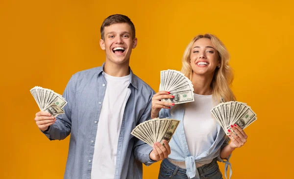 Joyful Millennial Couple Holding A Lot Of Cash In Hands — Stock Photo, Image