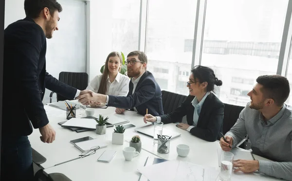 Satisfied HR managers shaking hands with applicant