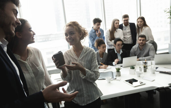 Young business people having conversation during coffee break