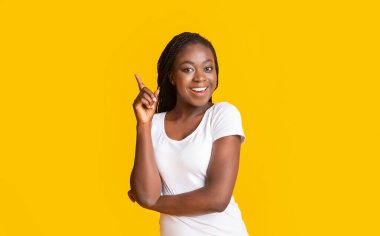 Neşeli afro kızın fikri var, parmağını kaldırıyor.