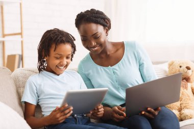 Afro mom and daughter doing school homework clipart