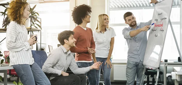 Top manager discussing teamwork meaning with coworkers