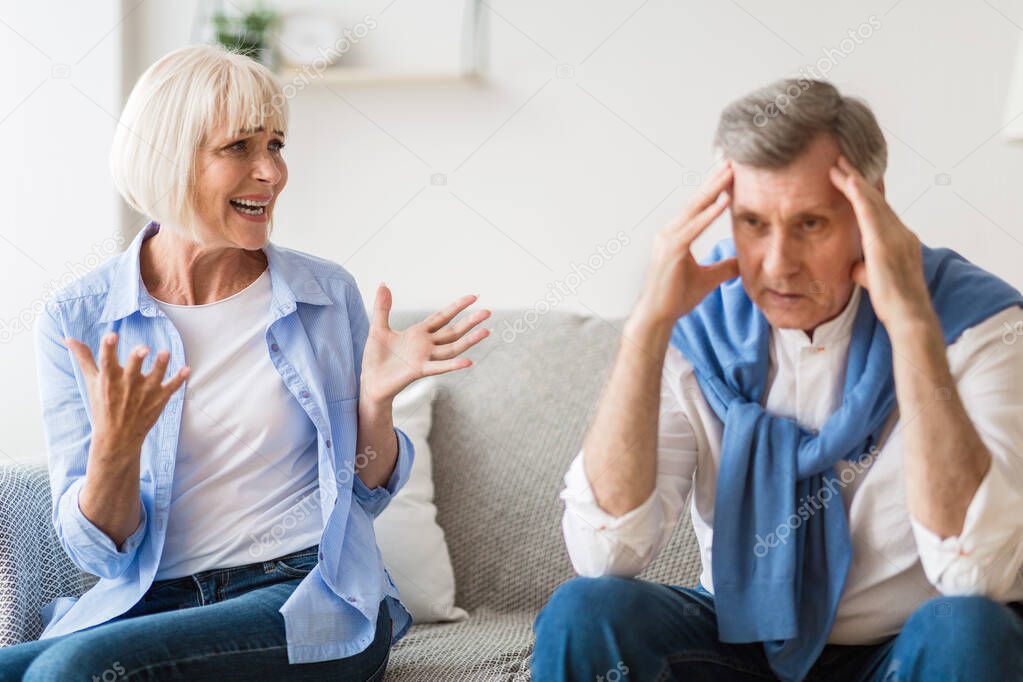 Couple arguing. Senior spouses quarrelling at home