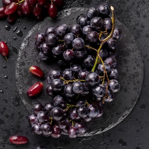 Close up of eco juicy dark blue grape on black — ストック写真