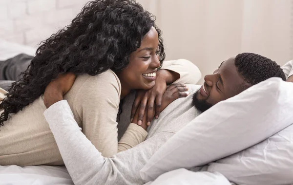 Romantic african couple spending time together in bed — ストック写真