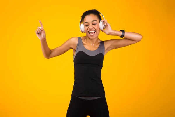 Dama negra en auriculares escuchando música bailando, filmación de estudio — Foto de Stock