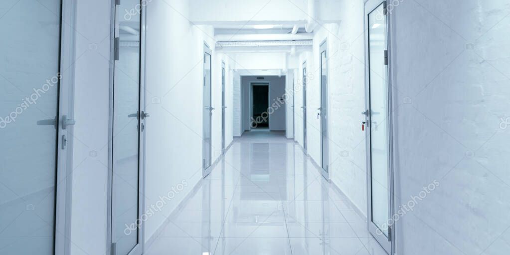 Empty corridor in hospital with closed doors