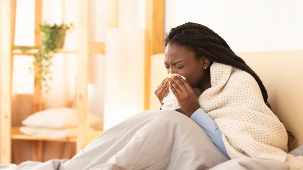 Sick Black Girl Blowing Nose Sitting In Bed, Panorama — Stock Photo, Image