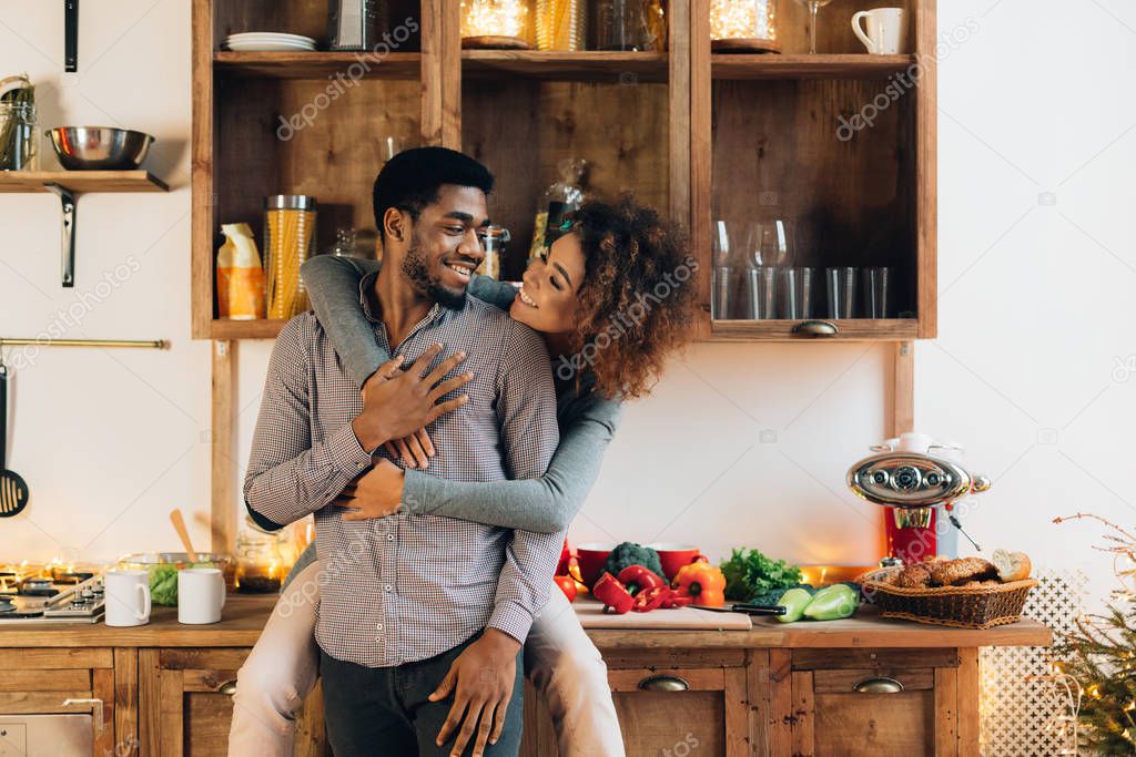 Loving african-american couple enjoying time together in kitchen