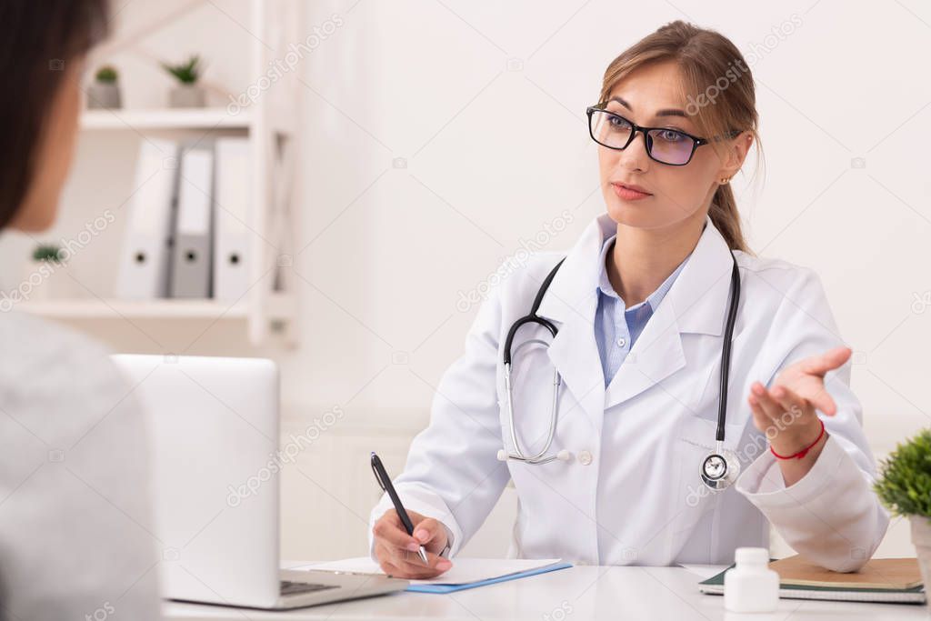 Doctor Lady Talking With Patient Prescribing Treatment Sitting In Office