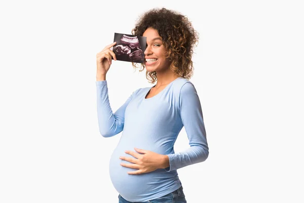 Mutlu hamile kadın doğmamış çocuğunun fotoğrafını çekiyor. — Stok fotoğraf
