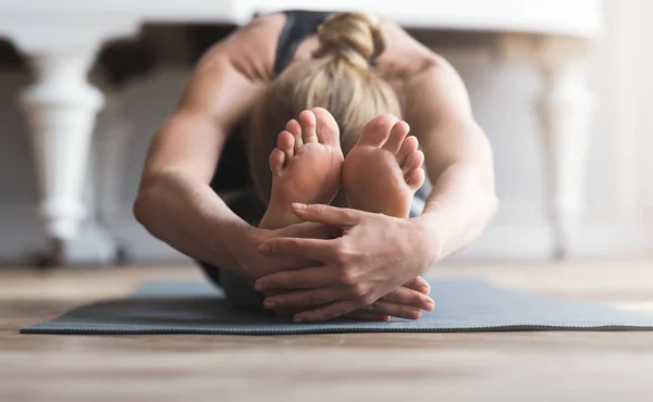 Young balerine stretching on sport mat before exercising — Stock Photo, Image