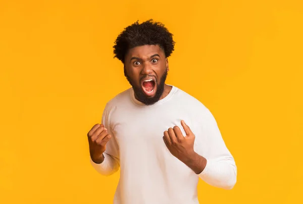 Woedend afro guy schreeuwen over oranje achtergrond — Stockfoto