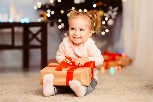 Happy baby girl enjoying Christmas gift at home — Stock Photo, Image