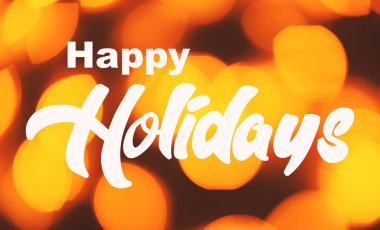 Bulanık turuncu ışıklar üzerine Mutlu Bayramlar mesajı olan tebrik kartı