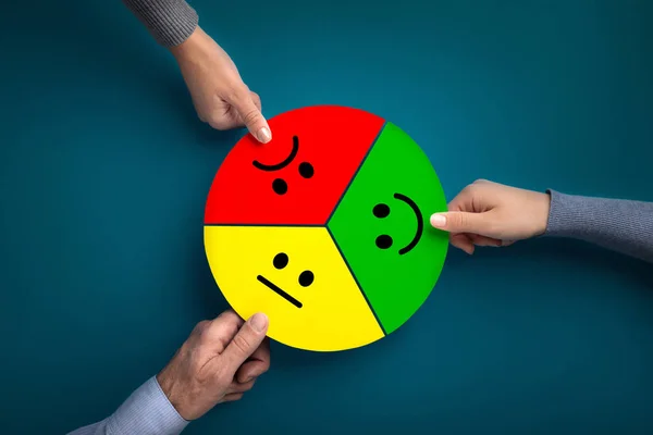 Customer hands giving feedback with smiley faces cards on blue — Stock Photo, Image